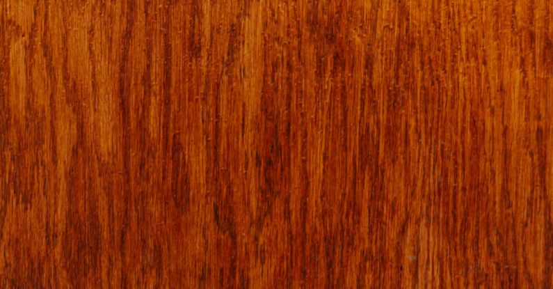 Wood Stain - Backdrop of brown wooden wall with wavy lines and blots on varnished surface with dense texture