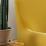 Laminate Furniture - Creative composition of comfortable yellow armchair with soft cushion and round wooden table with green home plant in pot against white wall in light apartment or flat with wooden floor