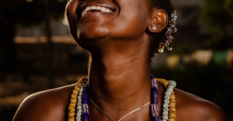 Beaded Necklaces - Portrait of Laughing Woman Wearing Heavy Beaded Neckla