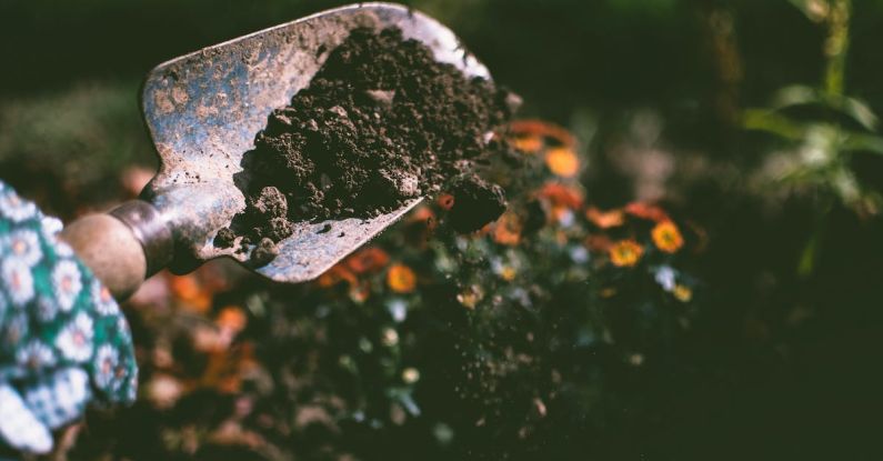 Gardening - Person Digging on Soil Using Garden Shovel