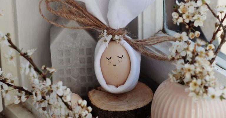 Easter Bunny - Egg and flowers on windowsill at home