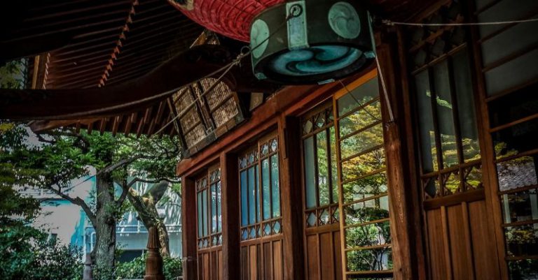 Paper Lantern - Red Green and Black Floating Lantern With Kanji Text Decoration Above Stairs