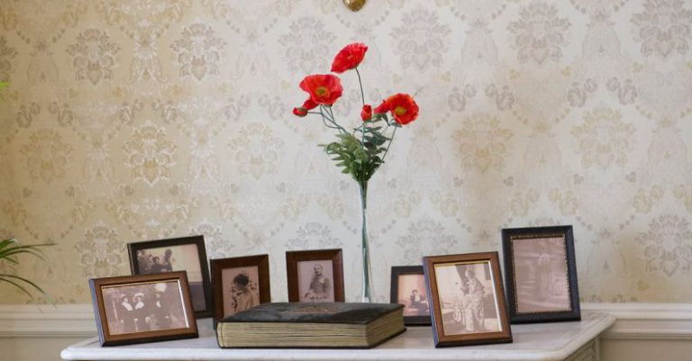 Vintage Dresser - A clock on a wall with pictures on it