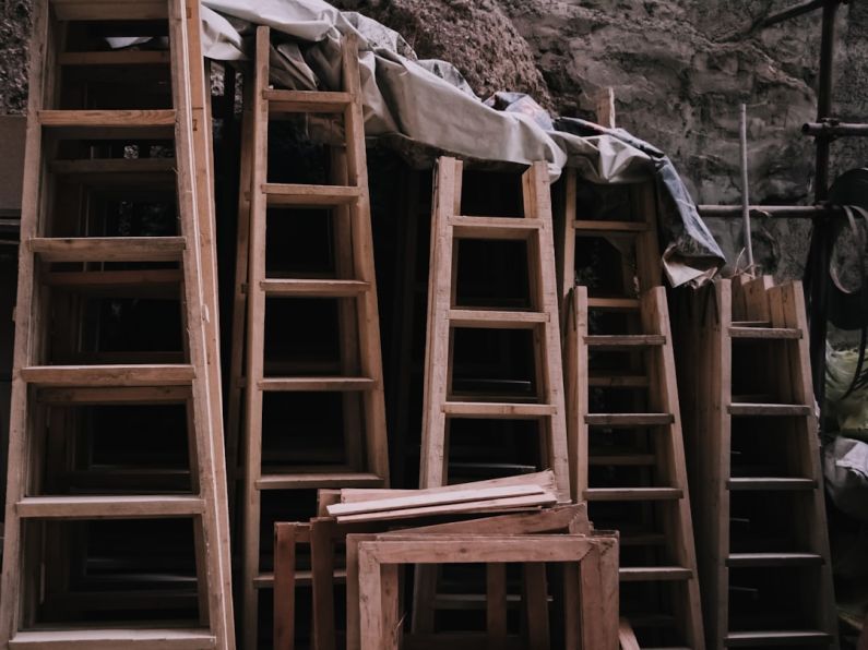 Ladders - a pile of wooden ladders sitting next to each other