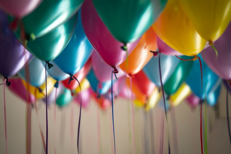 Surprise Party - selective focus photography of assorted-color balloons